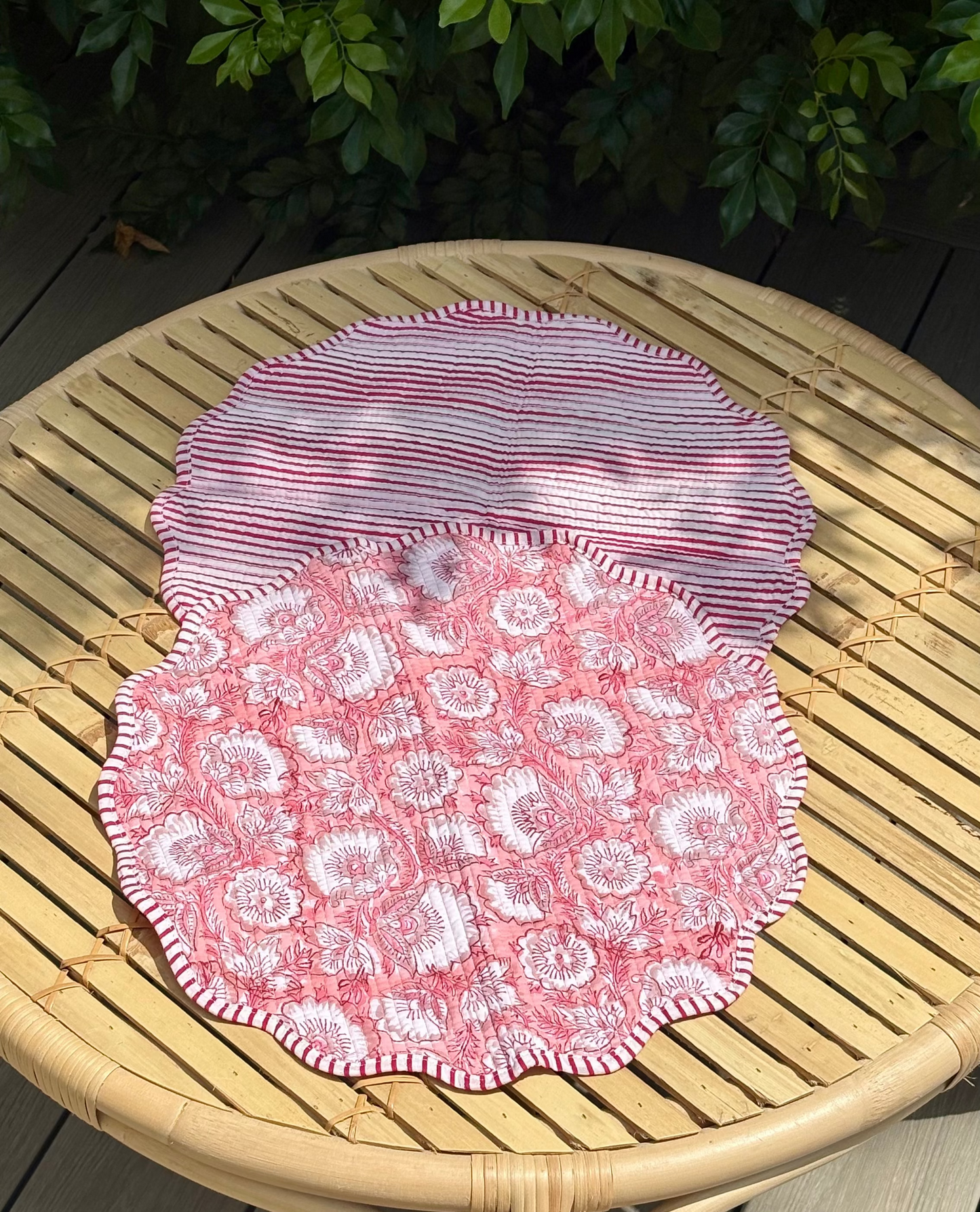 Pink lace doilies on a wooden table outdoors