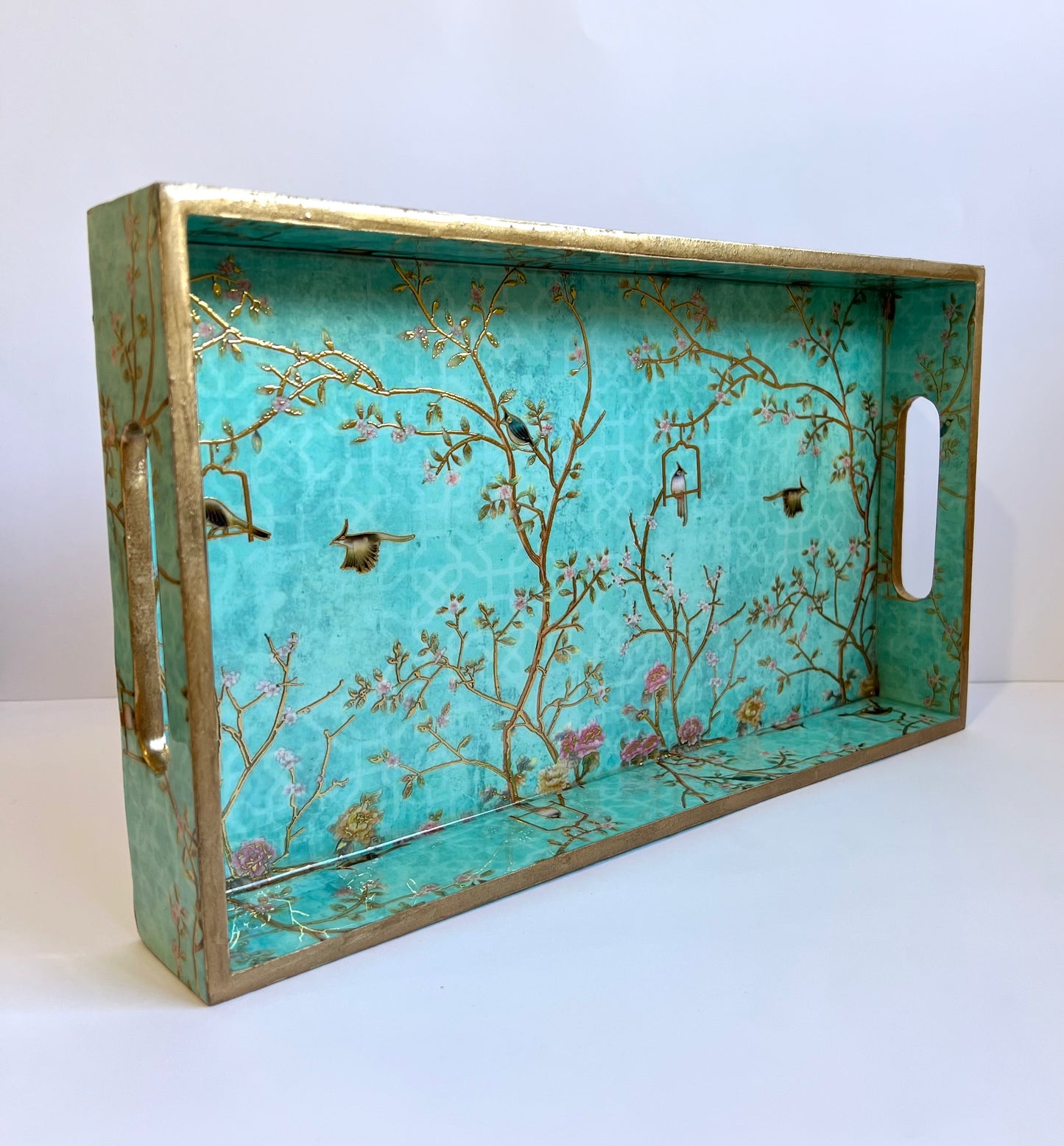 Decorative tray with nature-themed design on a white background