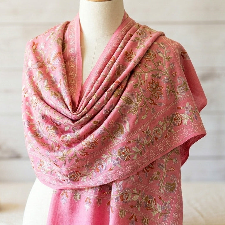 Mannequin wearing a pink floral scarf with a wooden background