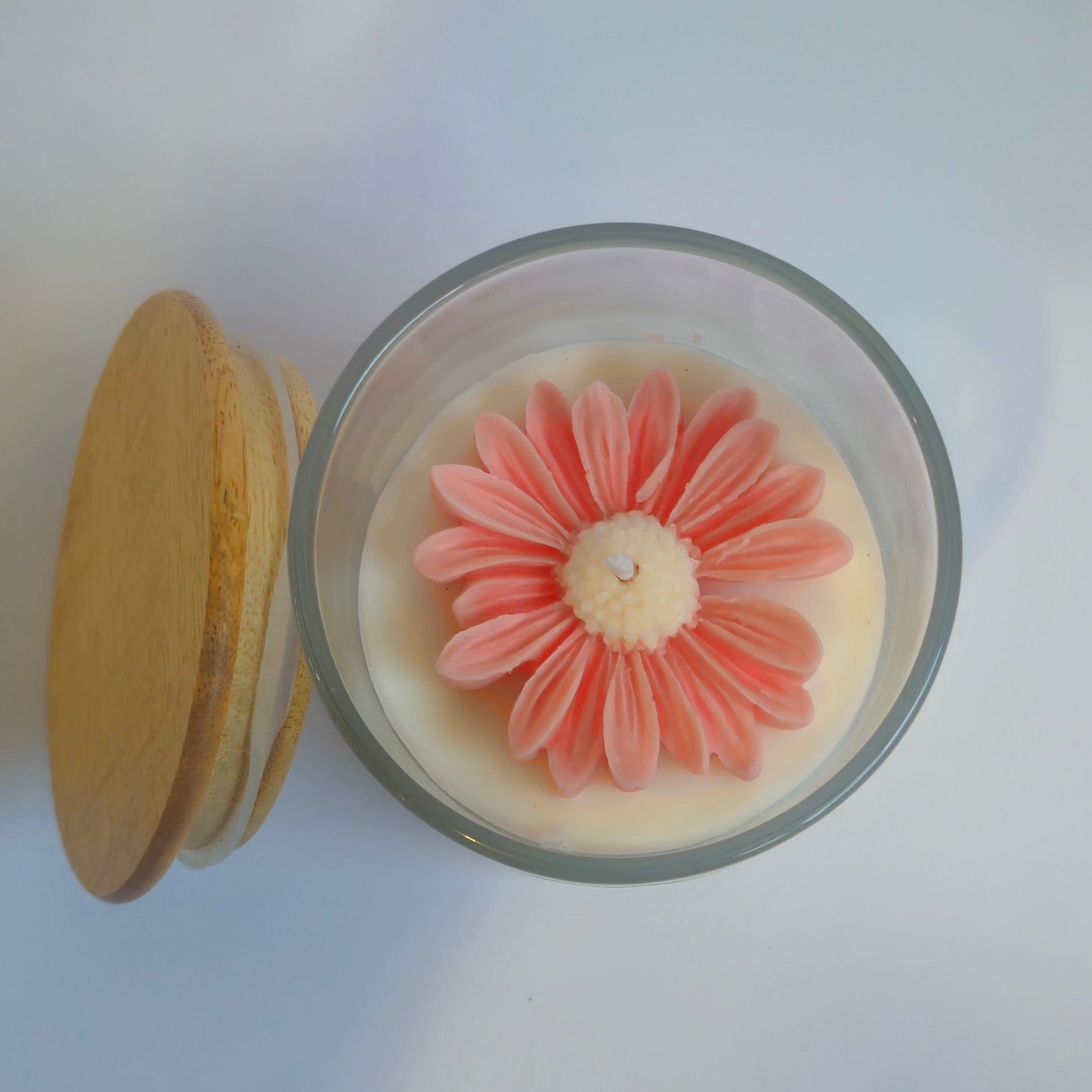 Small round container with a pink floral design on a white background