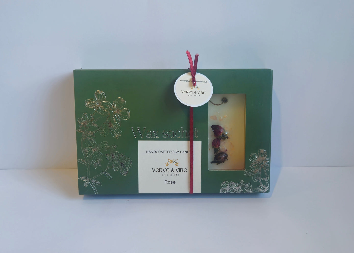 Green gift box with a tag on a white background