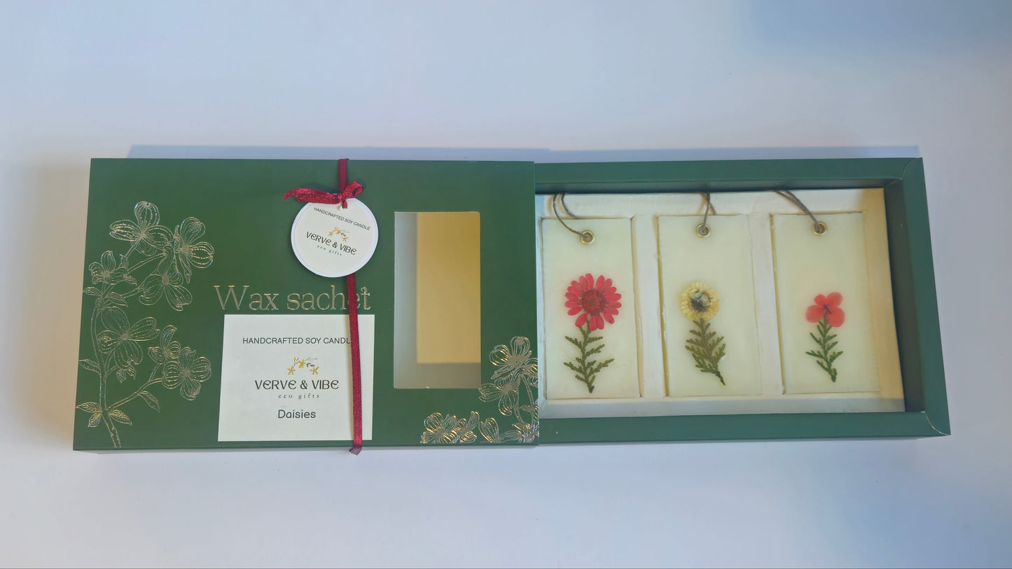 Green floral notebook with a ribbon on a white surface