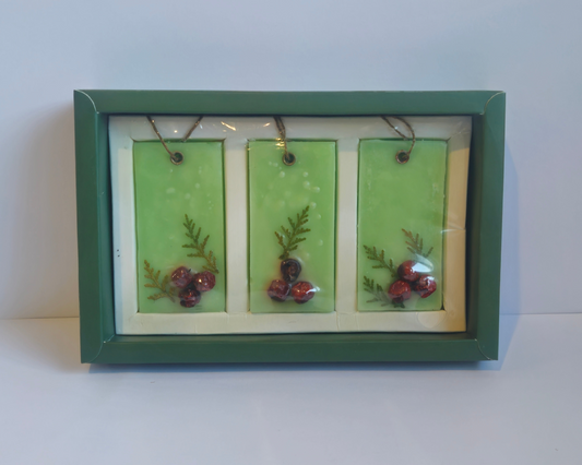Framed artwork with three small pictures on a white surface