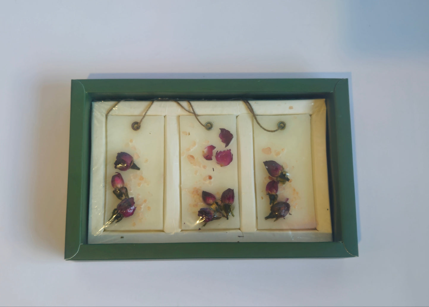 Small framed artwork with butterfly illustrations on a white surface