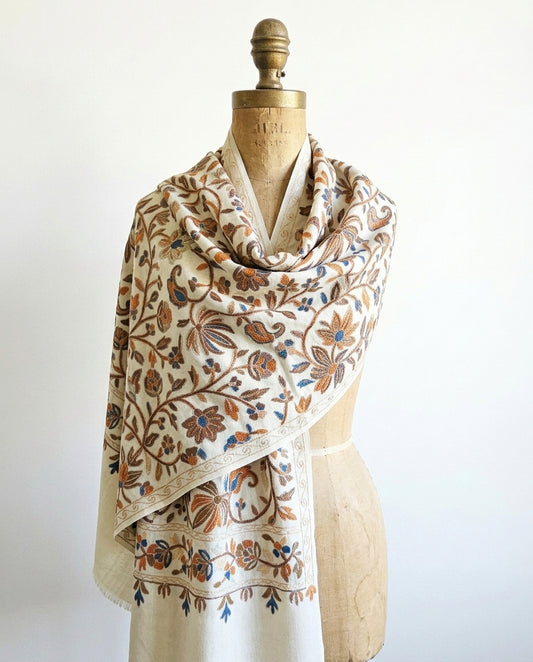 Floral patterned scarf on a mannequin against a white background