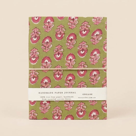 A stack of two handmade paper journals with a green and pink floral block print pattern, wrapped with a white paper band that reads 'HANDMADE PAPER JOURNAL'.