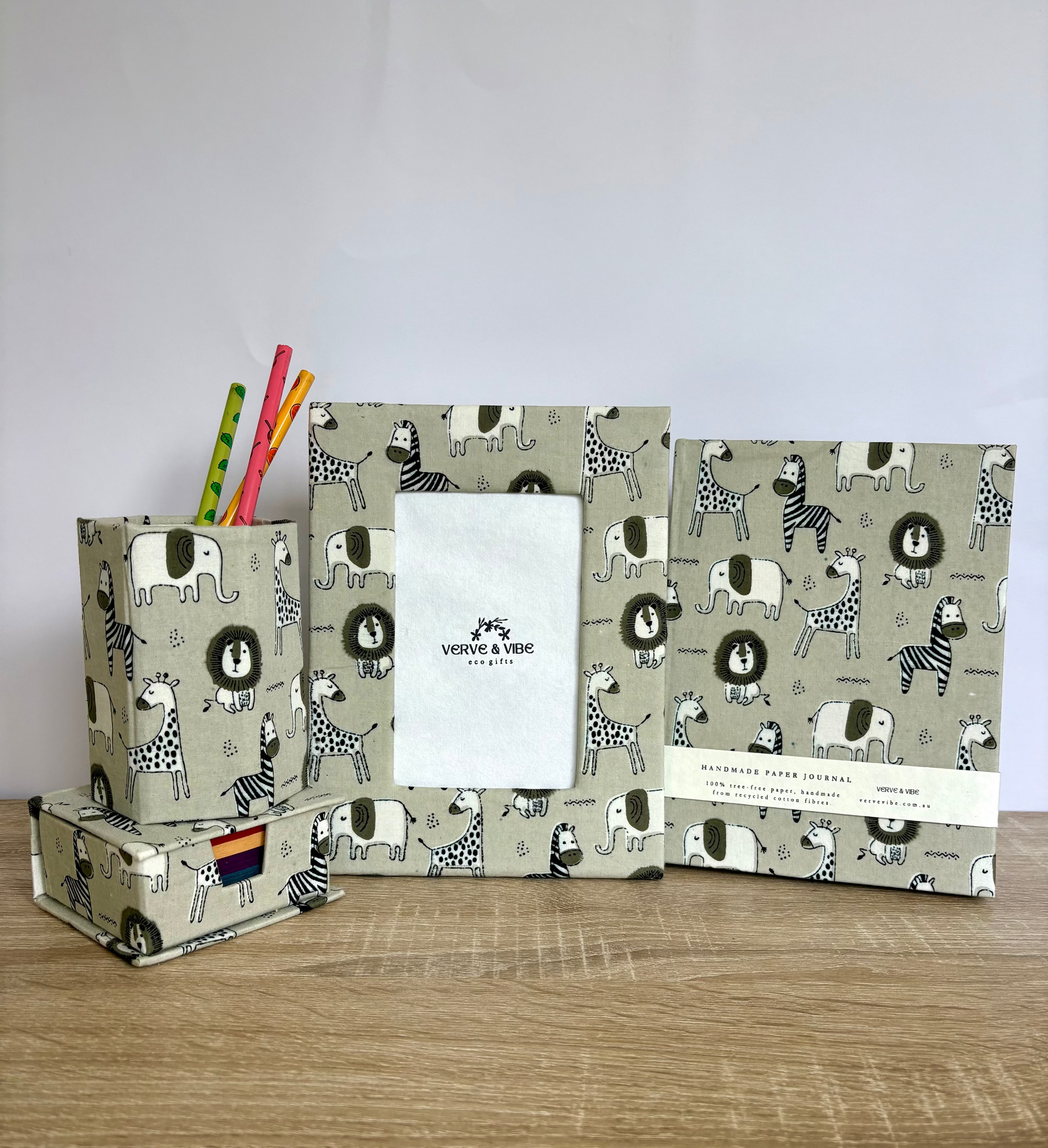 Set of stationery items with animal pattern on a wooden surface