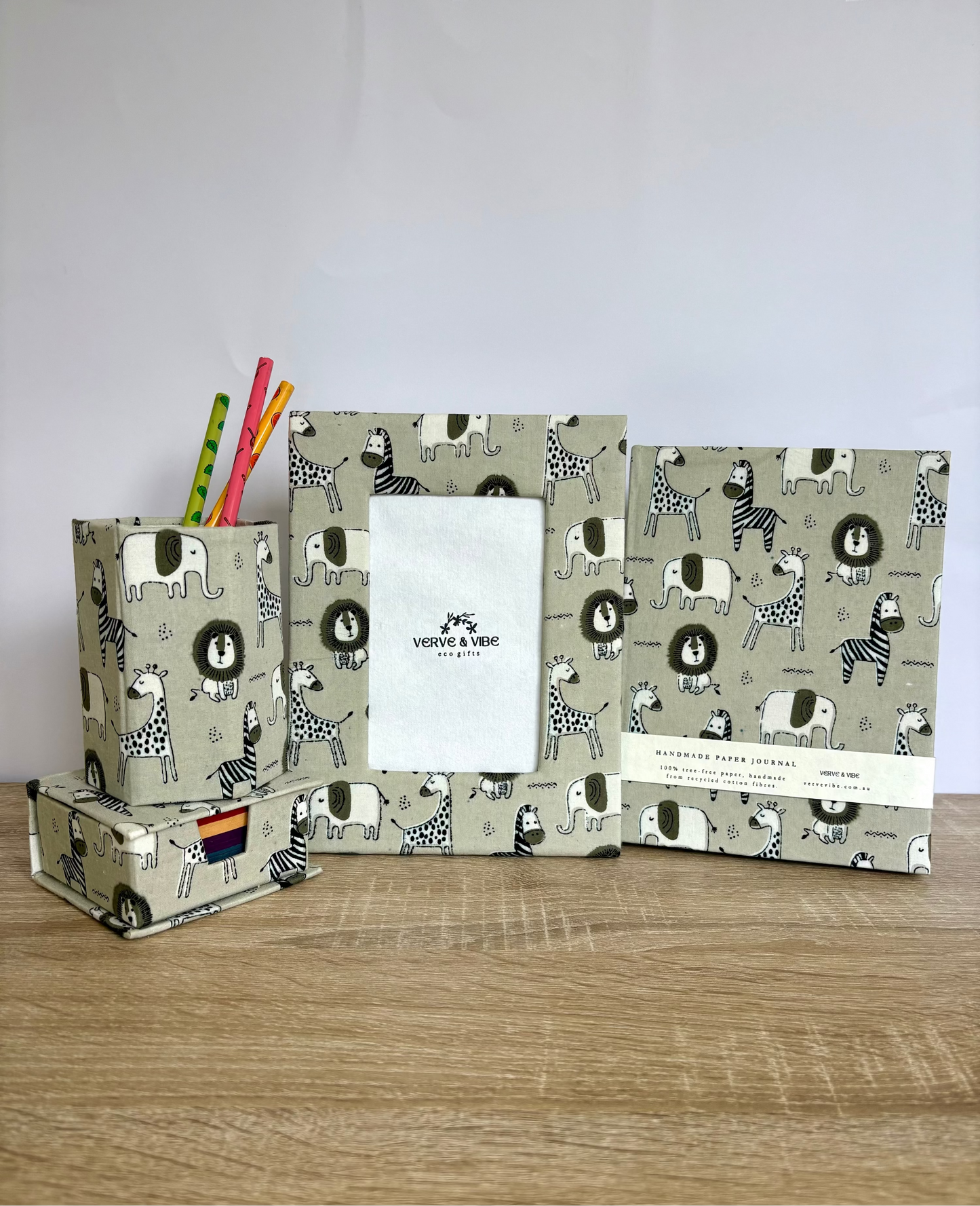 Set of stationery items with animal pattern on a wooden surface