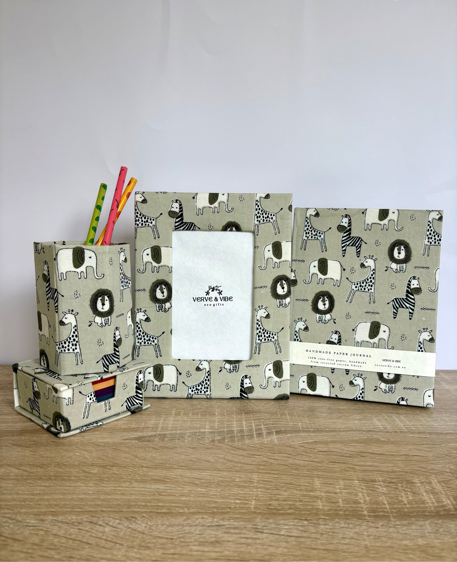 Set of stationery items with animal pattern on a wooden surface