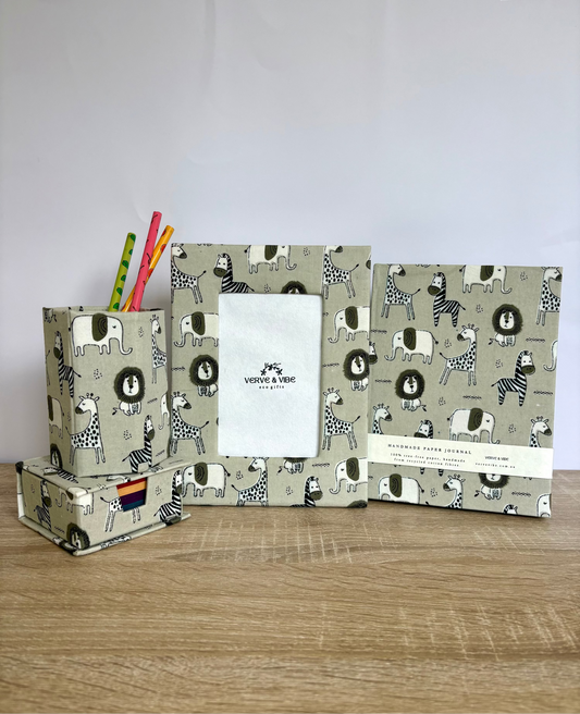 Set of stationery items with animal pattern on a wooden surface