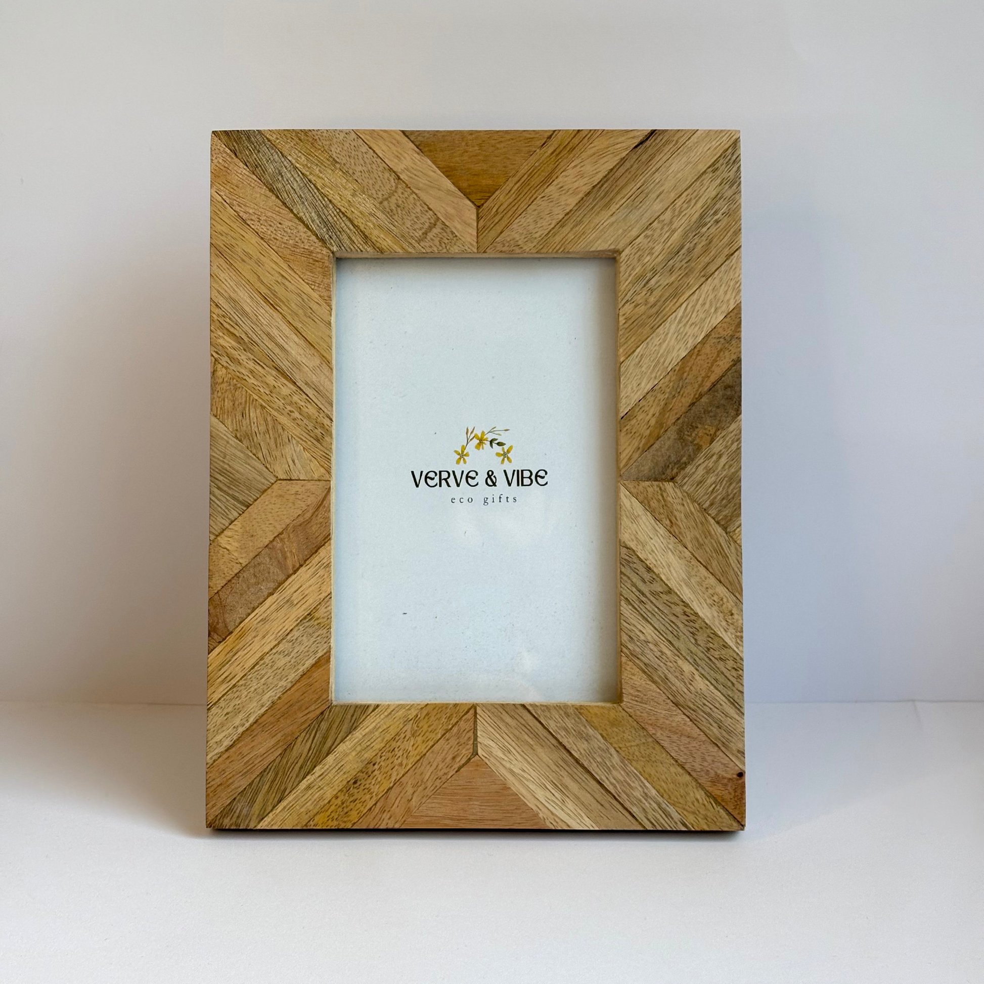Wooden picture frame with a chevron pattern on a white background