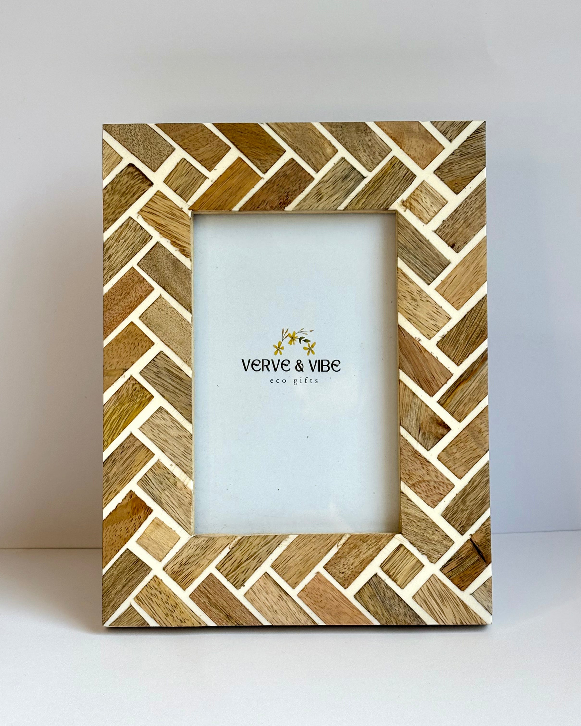 Wooden picture frame with herringbone pattern on a white background