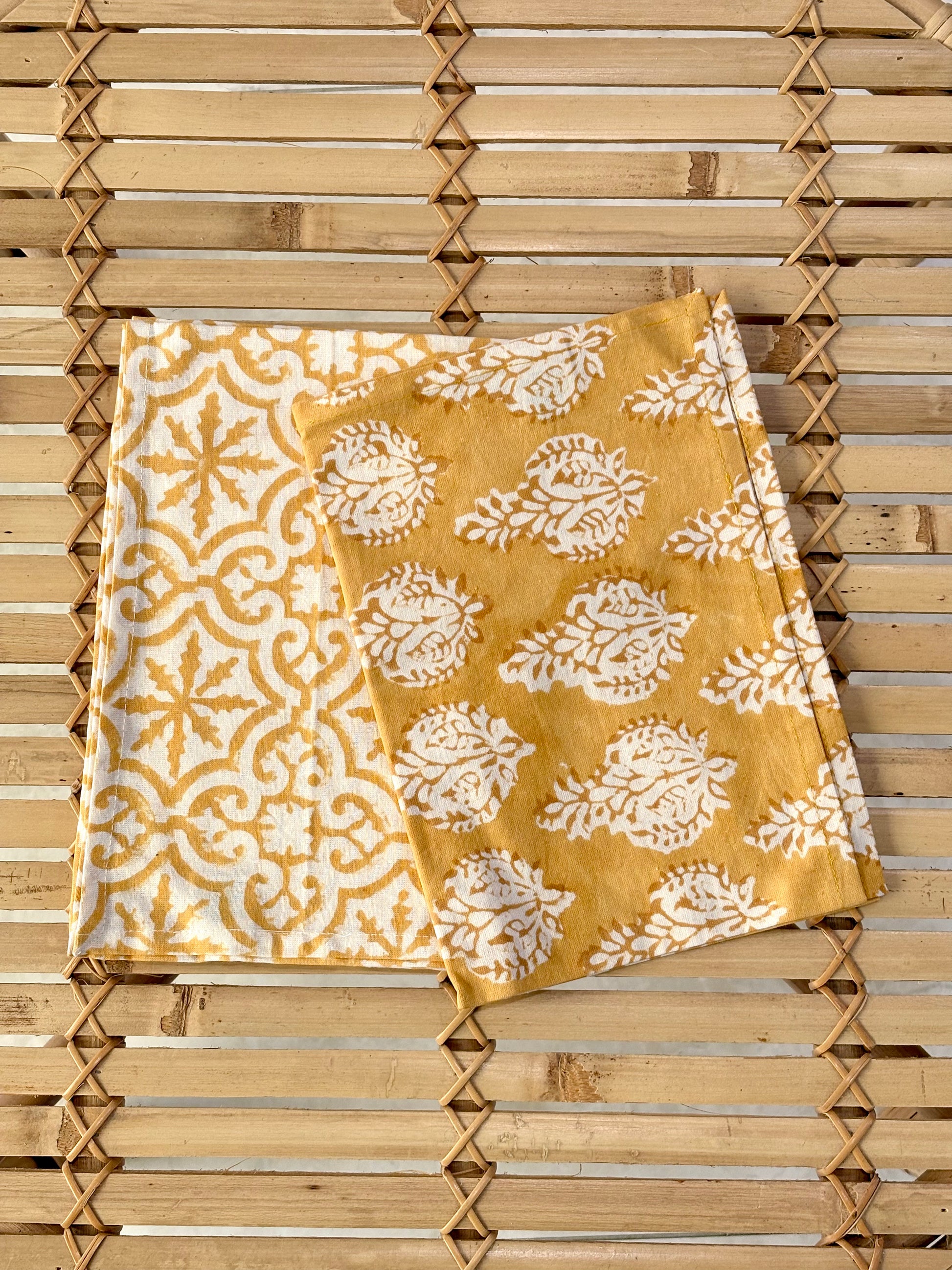 Yellow and white patterned towel on a wooden surface