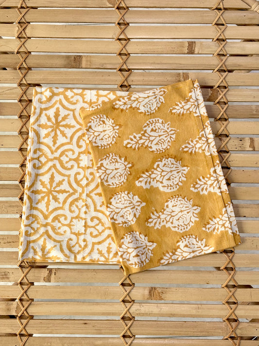 Yellow and white patterned towel on a wooden surface