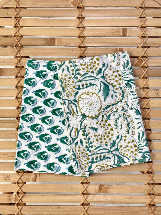 Green and white patterned fabric on a wooden surface