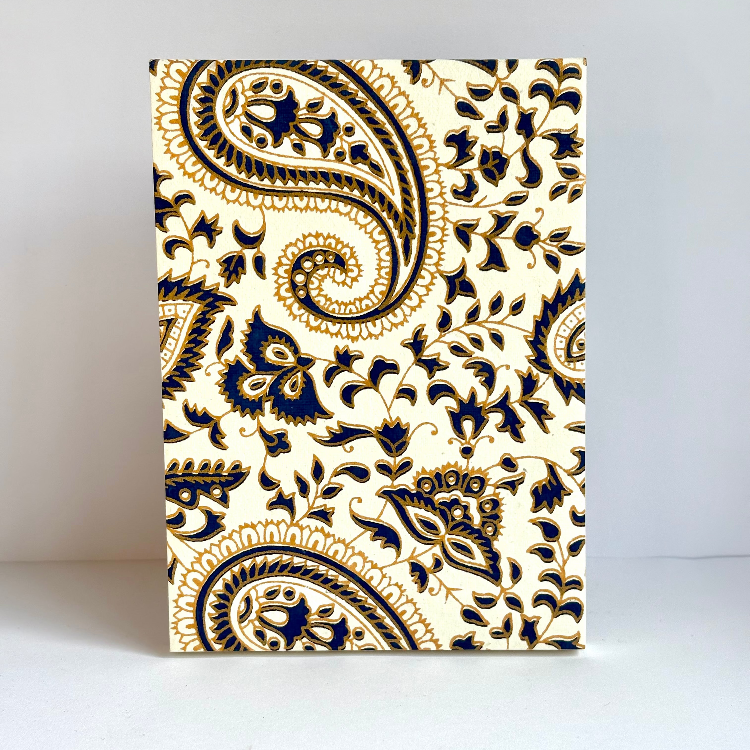 Notebook with blue paisley pattern on a white background