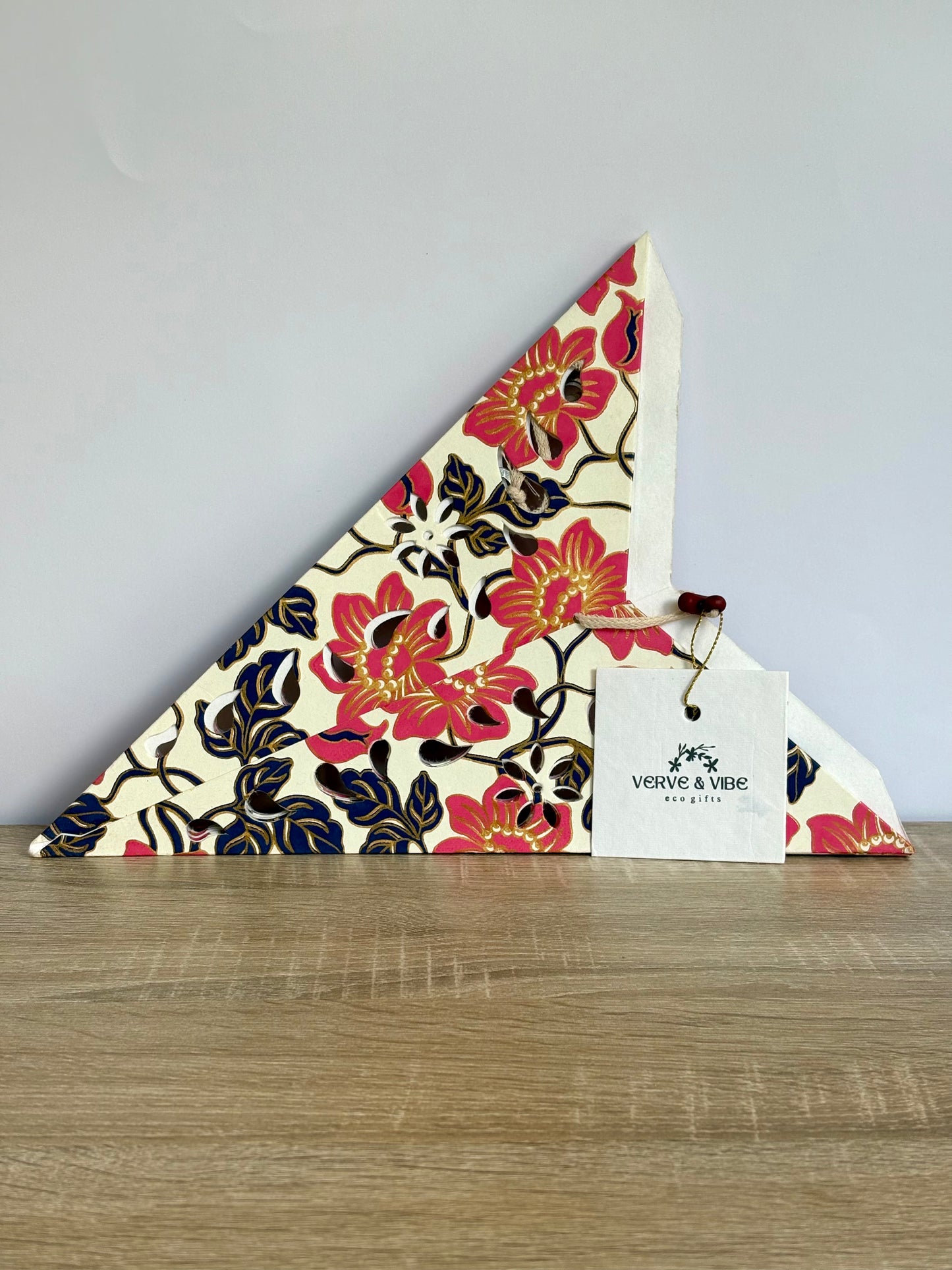 Floral-patterned product with a visible brand tag on a wooden surface