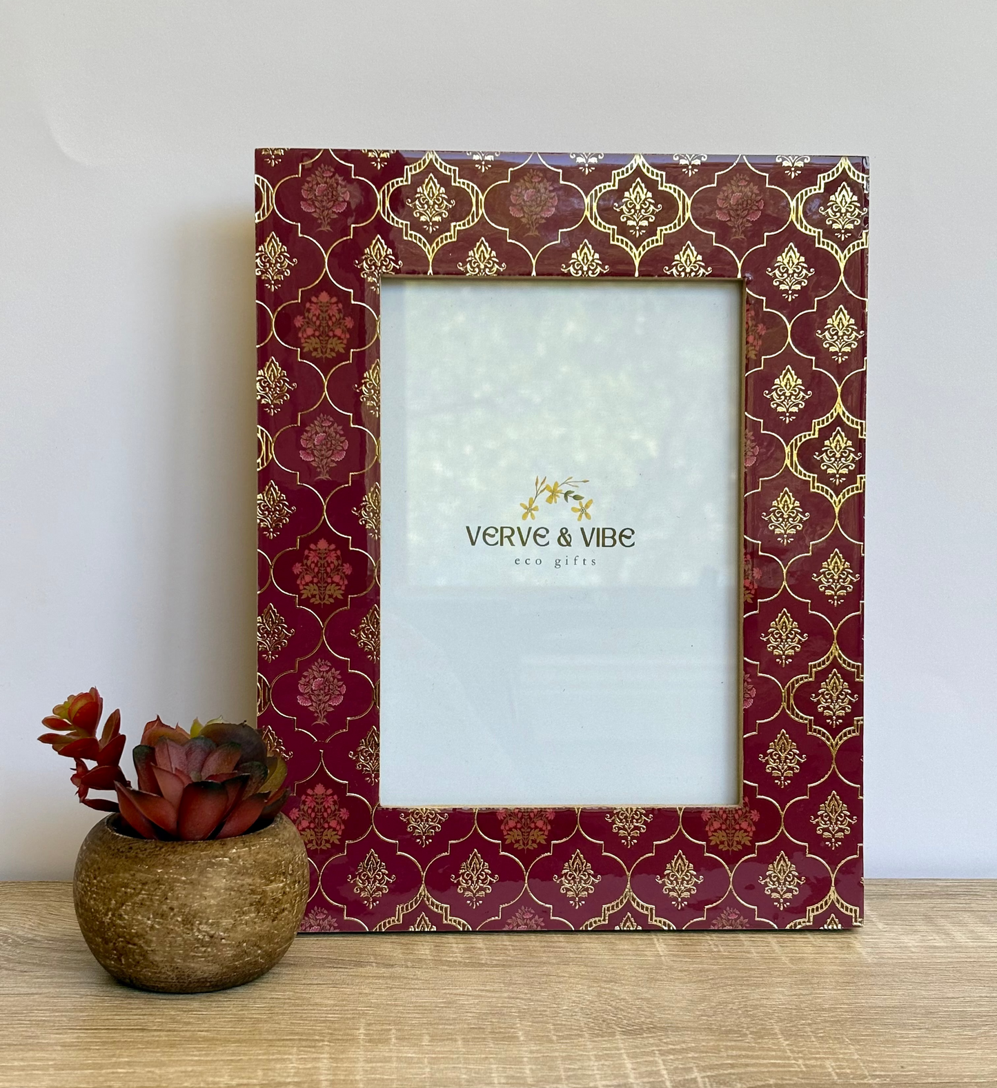 Decorative photo frame with gold patterns on a white background, featuring the brand 'Verve & Vibe'.