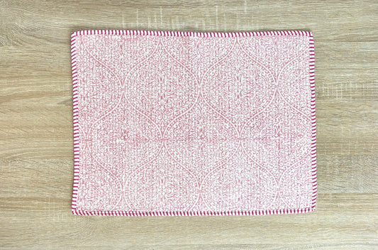 Pink and white patterned cloth on a wooden surface