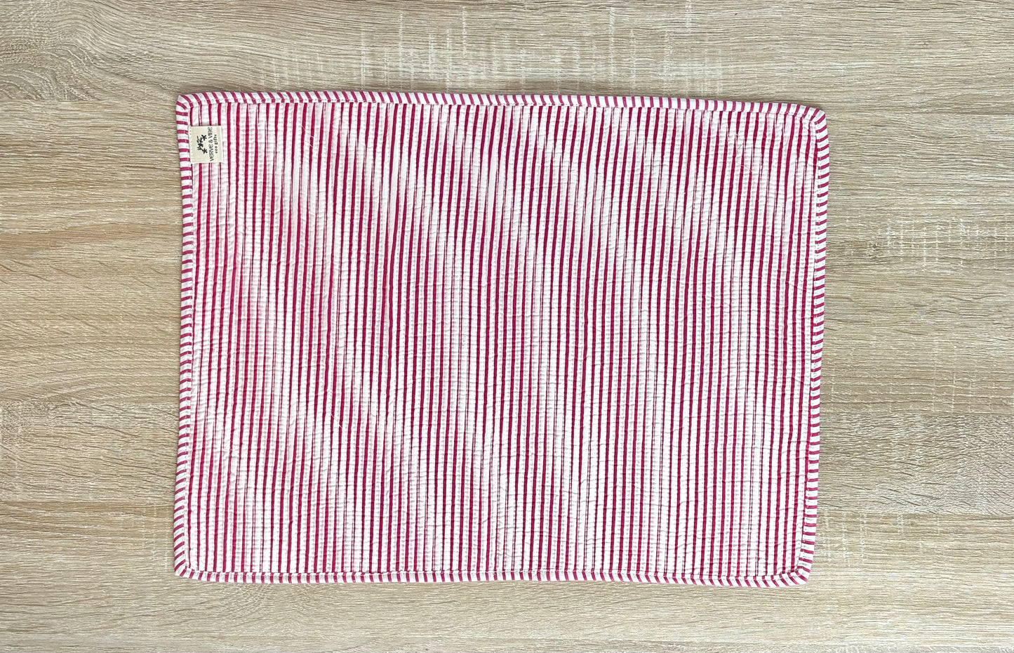 Red and white striped fabric on a wooden surface