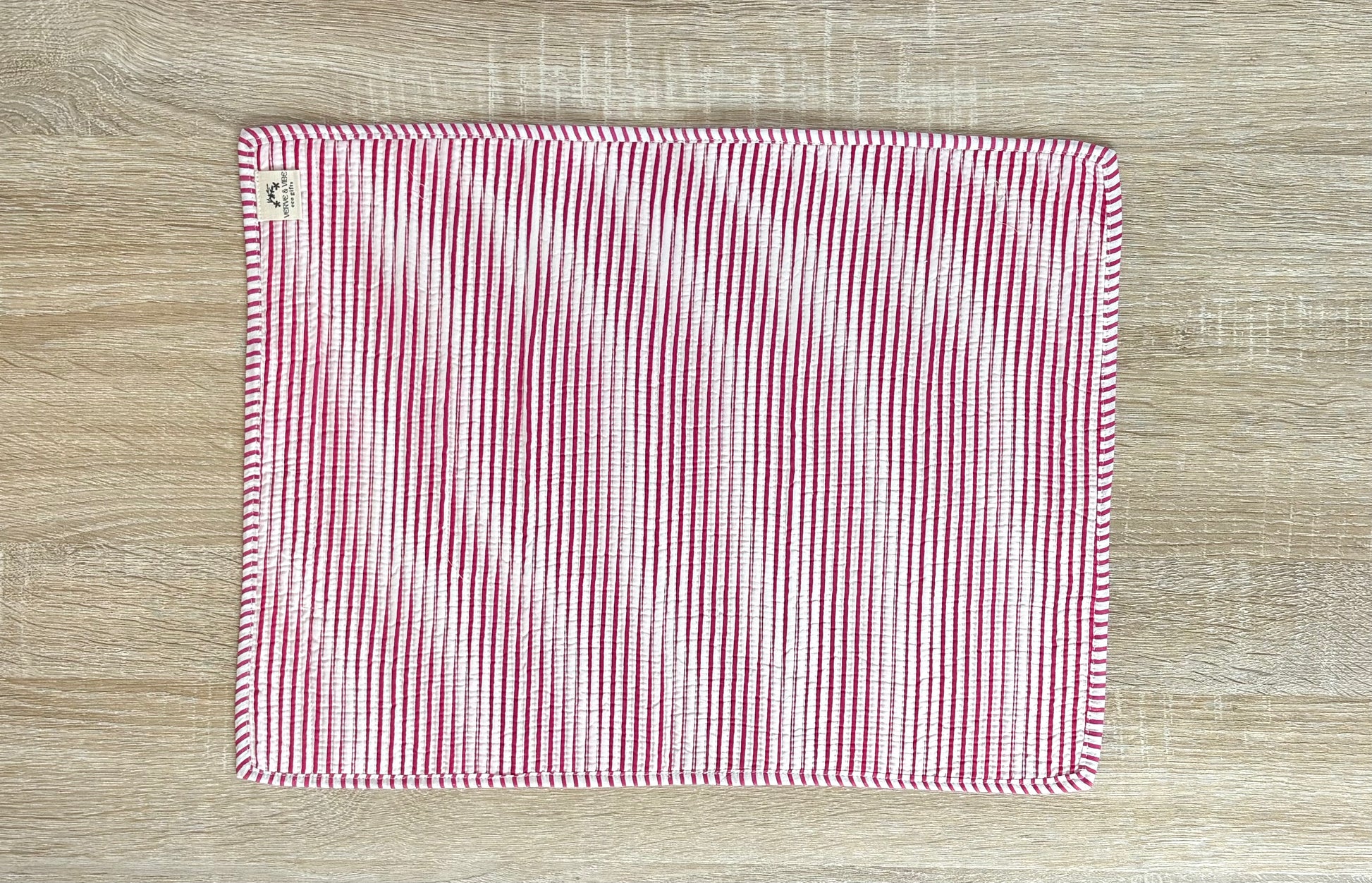 Red and white striped fabric on a wooden surface