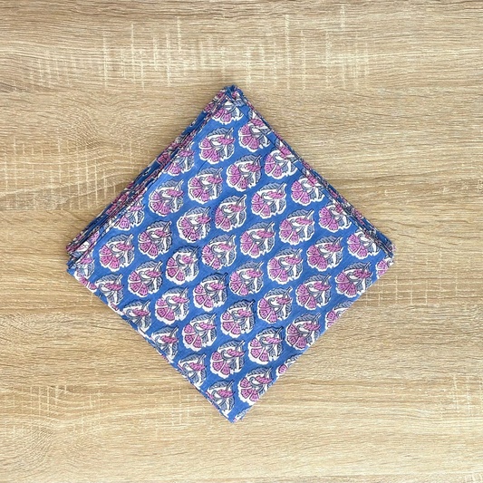 Folded fabric with a blue and pink pattern on a wooden surface