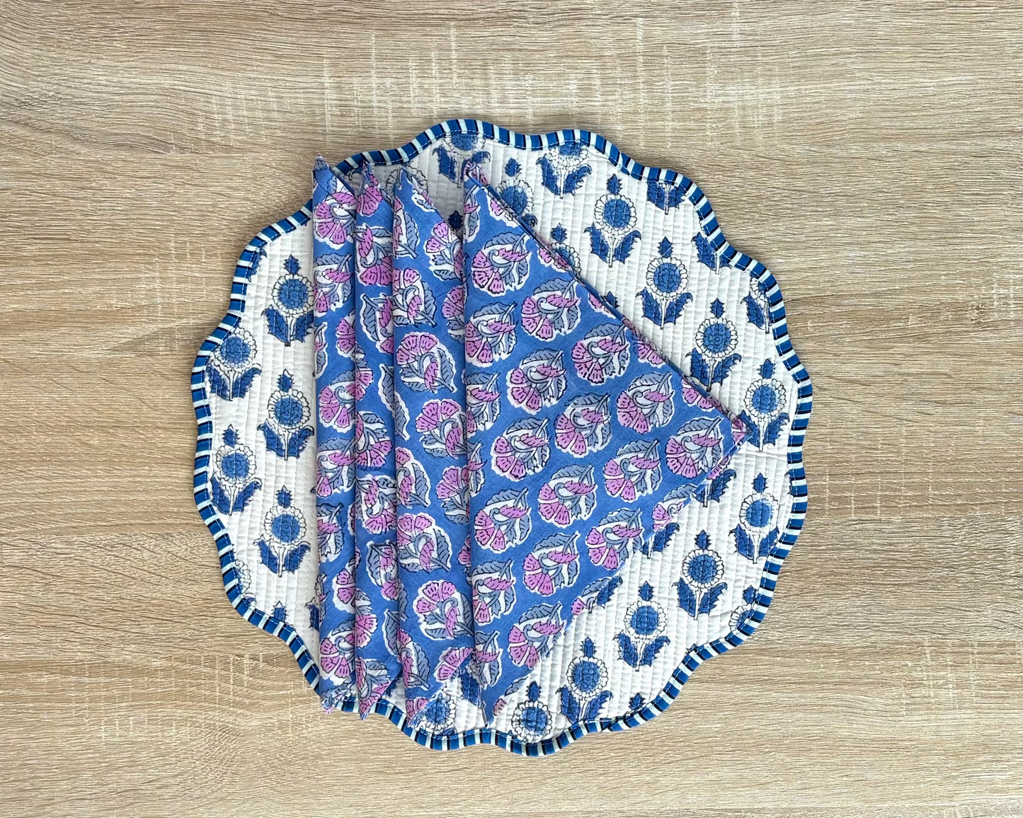 Set of blue and white patterned coasters on a wooden surface