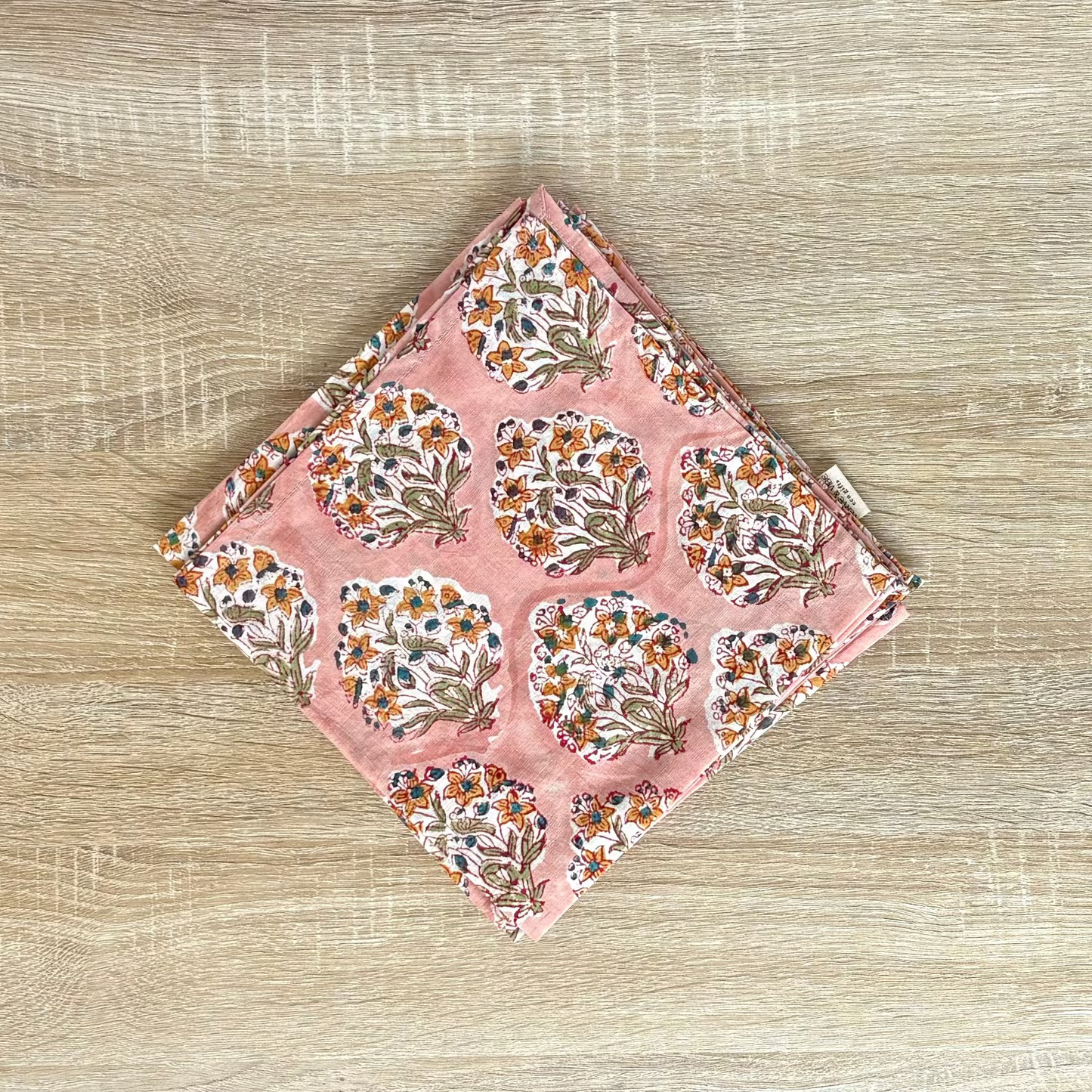 Floral patterned pouch on a wooden surface