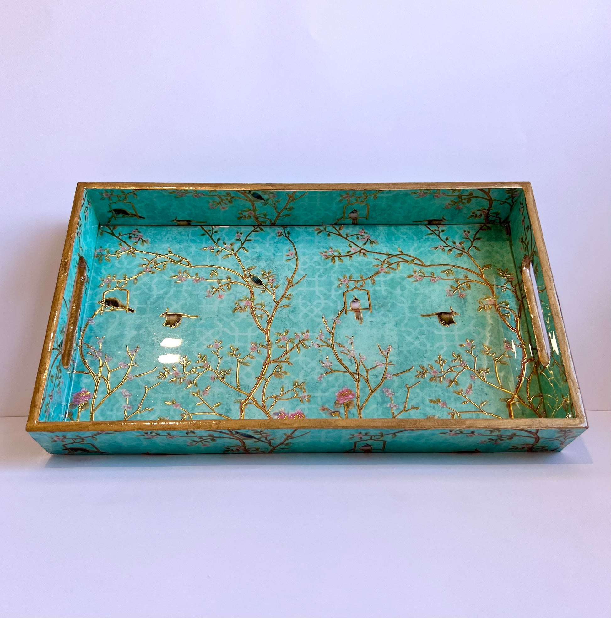 Decorative tray with floral and bird design on a white background