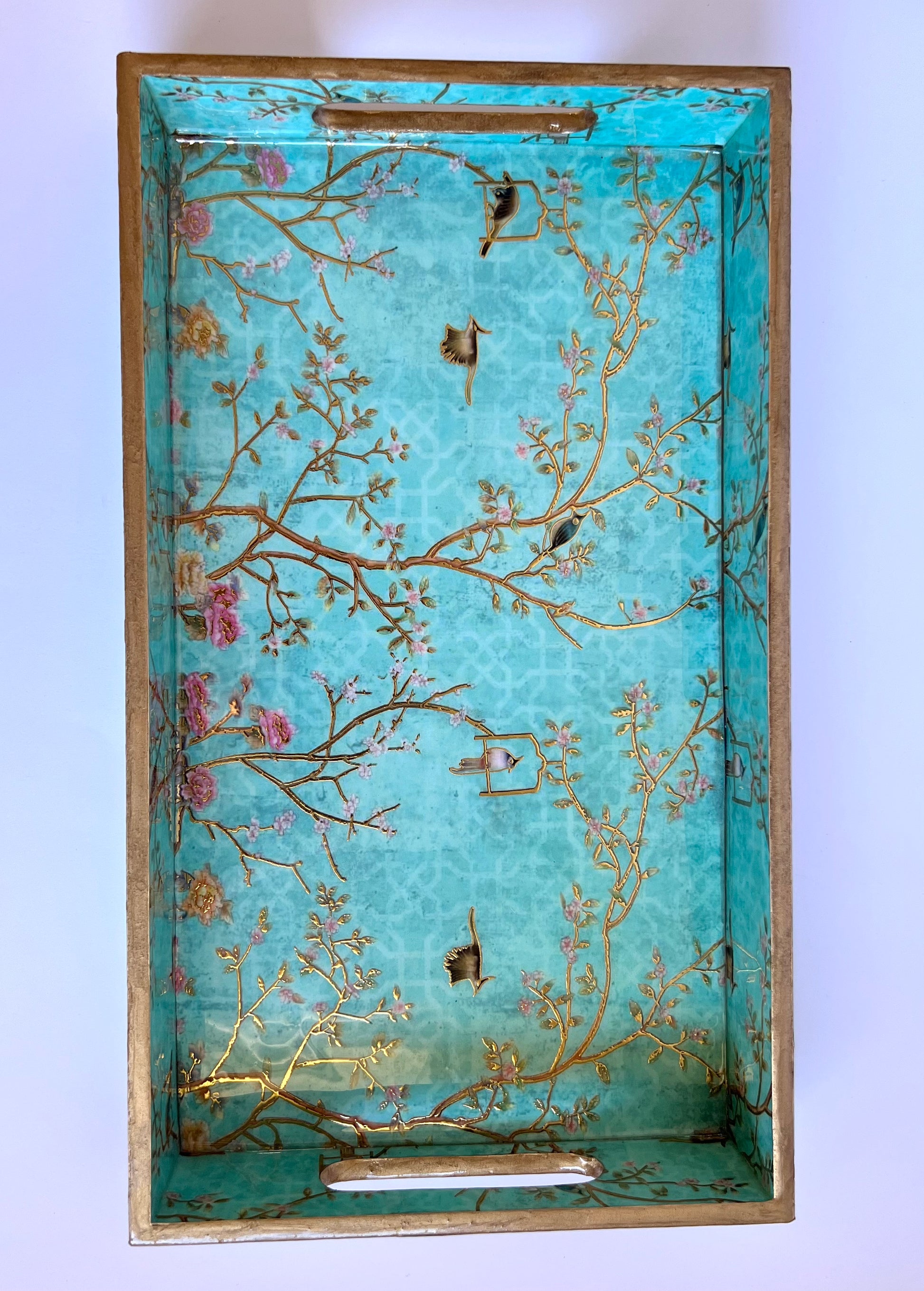 Decorative tray with floral and branch design on a light blue background