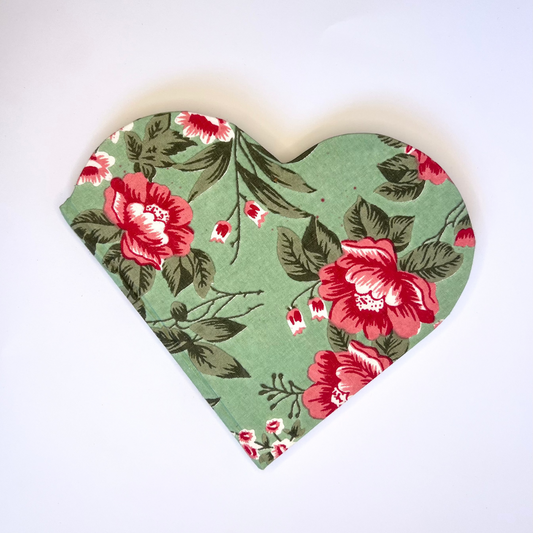 Heart-shaped fabric with red floral pattern on a white background