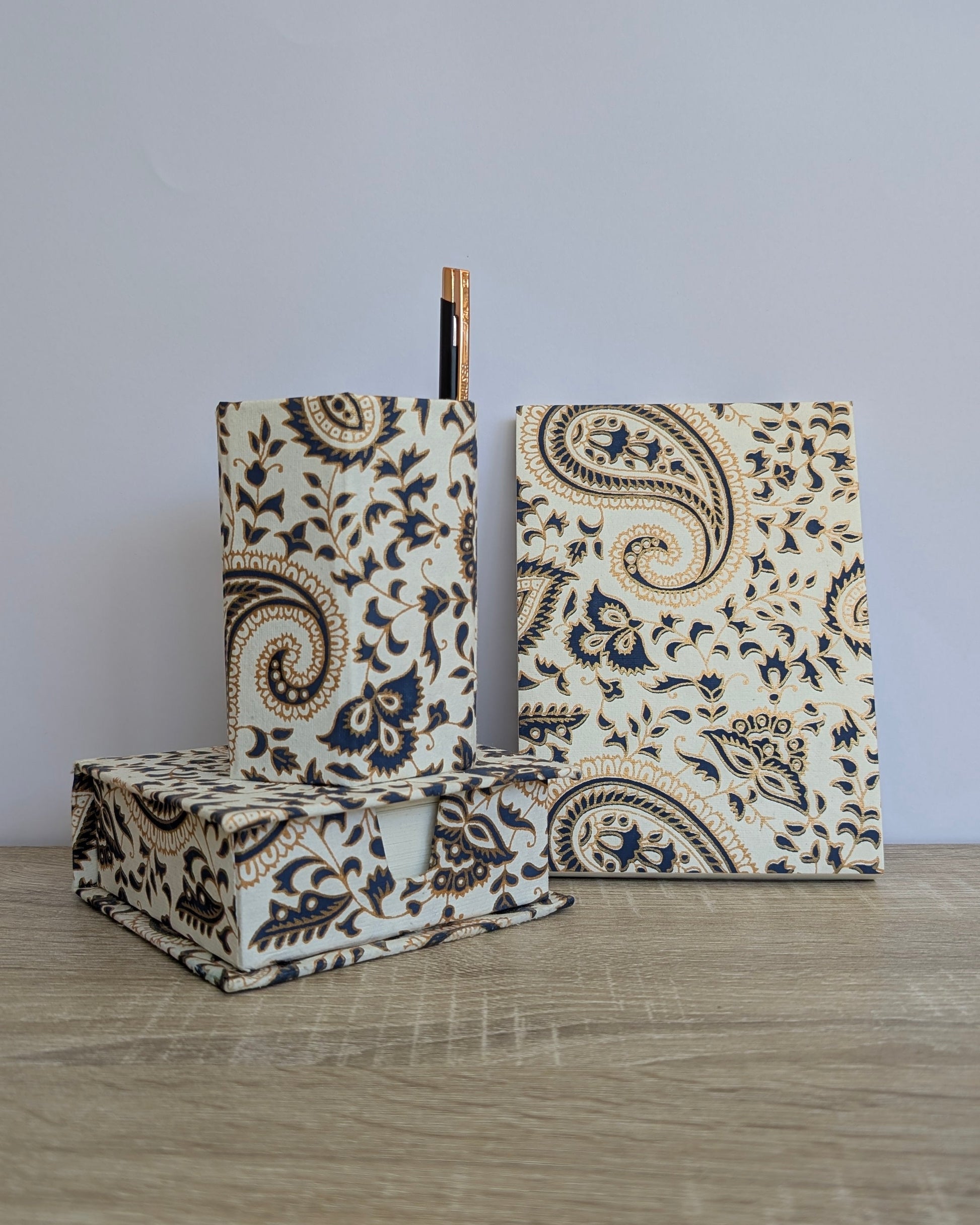 Decorative boxes with paisley pattern on a wooden surface